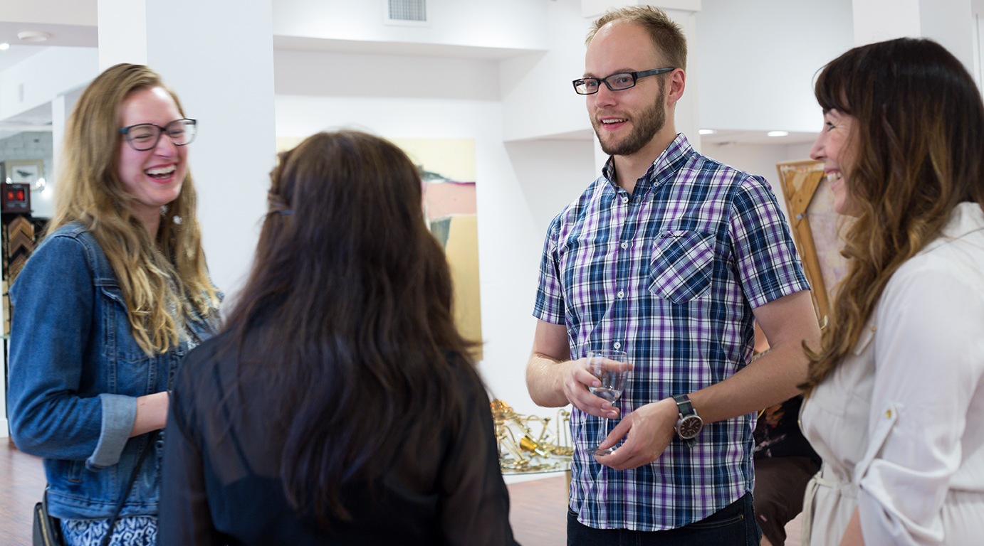 Skog chatting with gallery attendees.